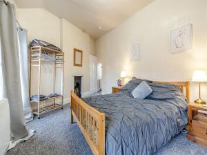 een slaapkamer met een bed en een open haard bij The Flat in Whitchurch