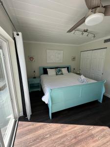 a bedroom with a bed with a blue bed frame at Seashell House in Clearwater