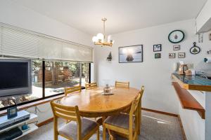 a dining room with a table and a television at Cozy & Bright Condo - Tamarack 18 home in Tamarack