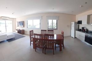 uma cozinha e sala de estar com mesa e cadeiras em Edificio Carmelitas insuperable una habitación em Assunção