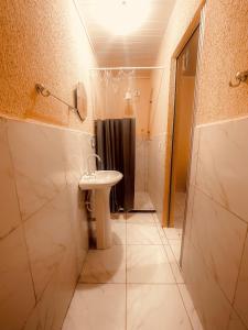 y baño con lavabo y ducha. en Pousada França, en Japaratinga