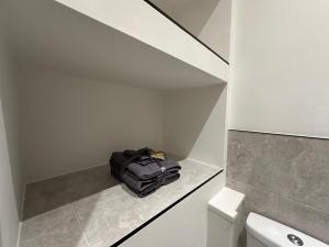 a black bag sitting on a counter in a bathroom at City Centre Studios @44 by DH ApartHotels in Peterborough