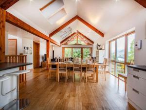 a kitchen and dining room with a table and chairs at Rathad An Drobhair in Garve