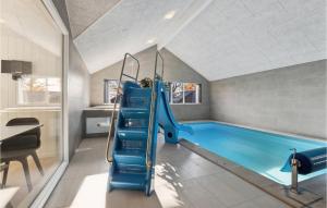 an indoor swimming pool with a slide in a house at Aqua 242 in Charlottenthal