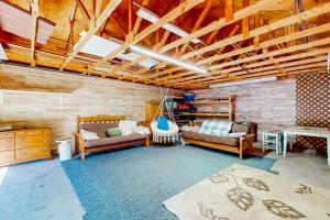 a living room with two couches and a room with wooden ceilings at The Cove in Golden