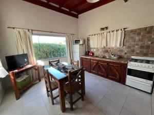 a kitchen with a table and a stove top oven at Ayres de Cobo in Mar de Cobo