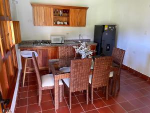 a kitchen with a table and chairs and a refrigerator at Hacienda La Tulia Eco Hotel in Toro
