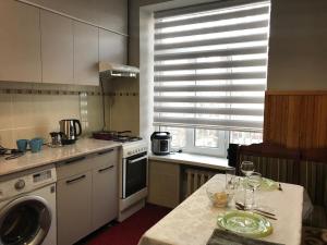 a kitchen with a table and a stove top oven at Уютный уголок рядом с ЦУМом и ГУМом in Bishkek