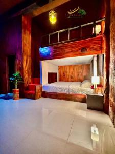 a bedroom with a large bed with a wooden headboard at เรือนร่มไม้รีสอร์ท RuenRomMai Resort in Ban Klang Mun +56 photos