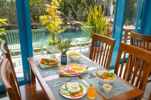 a table with plates of breakfast food on it at Villages HOÀNG ĐỨC gần biển XANH in Vung Tau