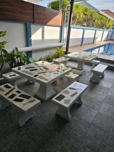 a group of tables and benches on a balcony at Pool Villa Baan Sanook Cha-am in Cha Am