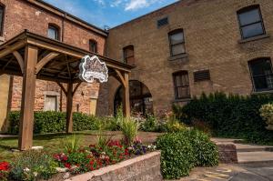 a brick building with a gazebo and flowers at The Anniversary Inn - Fifth South in Salt Lake City