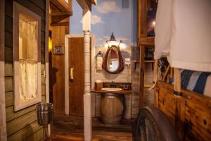 a bathroom with a sink and a mirror at The Anniversary Inn - Fifth South in Salt Lake City