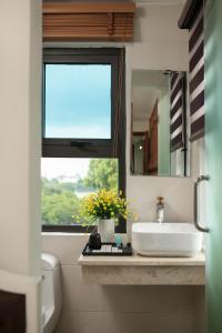 a bathroom with a sink and a window at TrangTrang Premium Hotel & Sky Bar in Hanoi