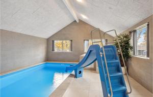 an indoor swimming pool with a slide in a house at Aqua 298 in Charlottenthal