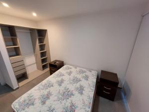 a small bedroom with a bed and a closet at Monte Hermoso del Este-Punta Tejada in Monte Hermoso