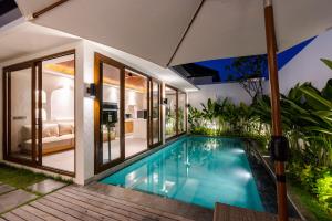 a swimming pool in the backyard of a house at J4 Villas Sanur in Sanur