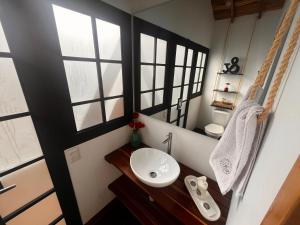 a bathroom with a sink and some windows at Chalets La Zima - Jaya in Curití