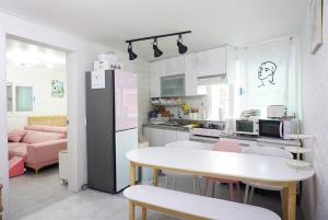 a kitchen with a table and chairs and a refrigerator at Gurosien 3 bedroom house in Seoul