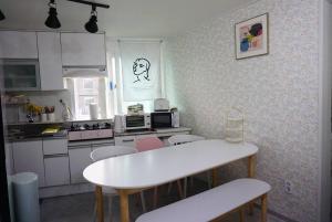 a kitchen with a white table and some chairs at Gurosien 3 bedroom house in Seoul
