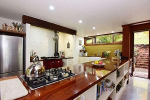 a kitchen with a stove and a counter top at Womberroo, Kangaroo Valley in Bellawongarah +10 photos
