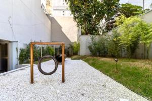 a playground in a yard with a swing at 1318 - Rentaqui Studio Frei Caneca Premium in Sao Paulo