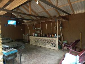 a living room with a table and a tv at Meemure WENASA HOTEL in Meemure