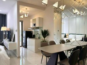 a dining room and kitchen with a table and chairs at New Saigon Royal Luxury Condo 4pax Best City View in Ho Chi Minh City