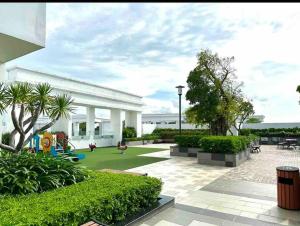 a garden with a playground and a white building at New Saigon Royal Luxury Condo 4pax Best City View in Ho Chi Minh City