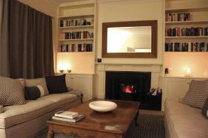a living room with a couch and a fire place at Somerset, Berrima, Southern Highlands in Berrima