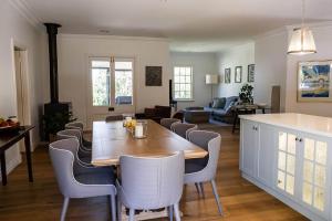 a kitchen and living room with a wooden table and chairs at Somerset, Berrima, Southern Highlands in Berrima