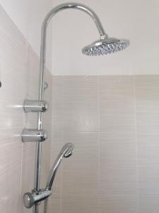 a shower with a shower head in a bathroom at La villa karukera in Sainte-Rose