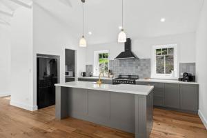 a kitchen with a large island in the middle at Paddington, Kangaroo Valley in Barrengarry