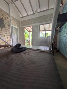 a room with a bed with a blanket on it at EKUKU lake houses in Kumbalgama