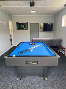 a living room with a pool table in a room at Family Adventure Get Away in Rotorua