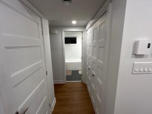 a hallway with white drawers and a door at Unactivated in Longueuil