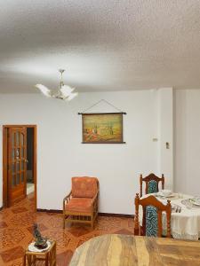 a living room with a table and a chair at Moonlight, Galápagos in San Cristóbal