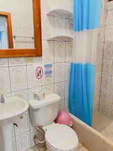 a bathroom with a toilet and a sink at Moonlight, Galápagos in San Cristobal