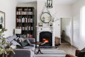 a living room with a couch and a fireplace at Dunmore Farm in Upper Lurg