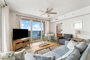 a living room with a couch and a tv at Shores Of Panama 1403 in Panama City Beach