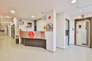 a hallway of a hospital with a sign on the wall at Hotel Isher International in Gandhinagar