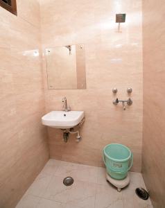 a bathroom with a sink and a toilet at New Royal Hotel in New Delhi