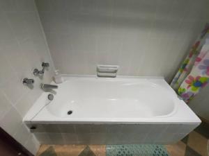 a white sink in a bathroom with a shower at Seaview Deluxe Studio couples room S in Tanjung Bungah