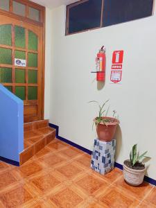 a hallway with a fire extinguisher on the wall at Moonlight, Galápagos in San Cristóbal