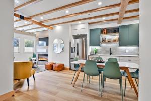 a kitchen and dining room with a table and chairs at Ravens Crest Lodge - Stunning Views Perfectly Located on Main Street in Canmore