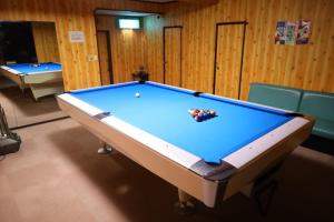 a pool table in a room with chairs at Luna House in Nakano