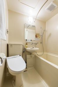 a bathroom with a white toilet and a sink at Sai Hotel in Shizuoka