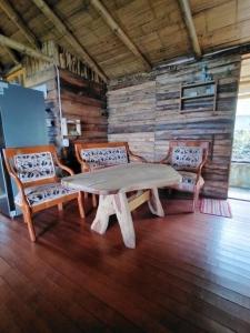 Una mesa y cuatro sillas en una habitación en Cabaña Mirador del Otún, en Pereira