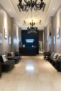 a large lobby with couches and a chandelier at Atlantis Apartment Nguyen Thai Hoc in Hanoi