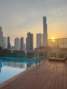 a swimming pool with a view of a city skyline at Top High Airport Link Hotel, Bangkok in Bangkok